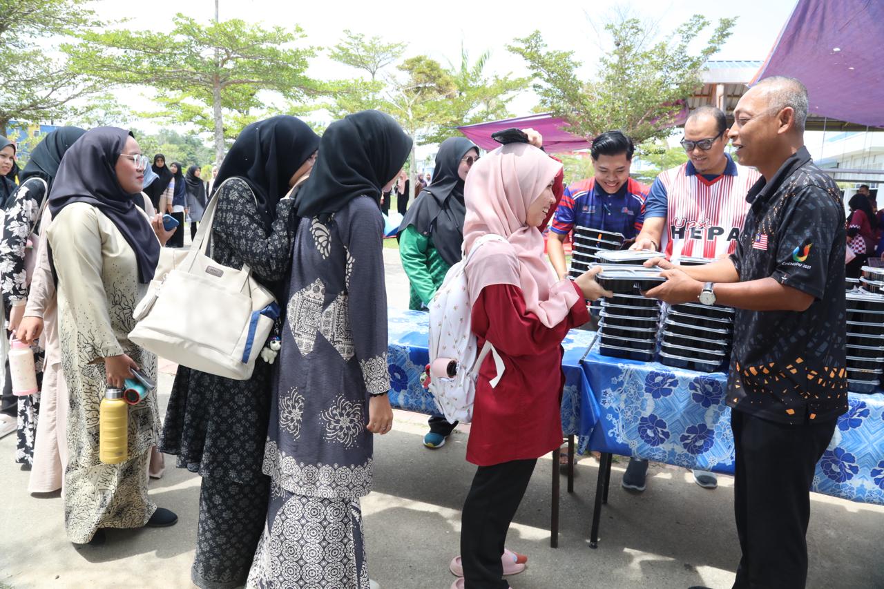 Dr. Norkhalid (kanan) ketika menyerahkan pek makanan kepada penuntut UPSI pada Program Dapur Kasih Bitara di Perkarangan Masjid Al-Mursyidin, Kampus Sultan Azlan Shah UPSI.